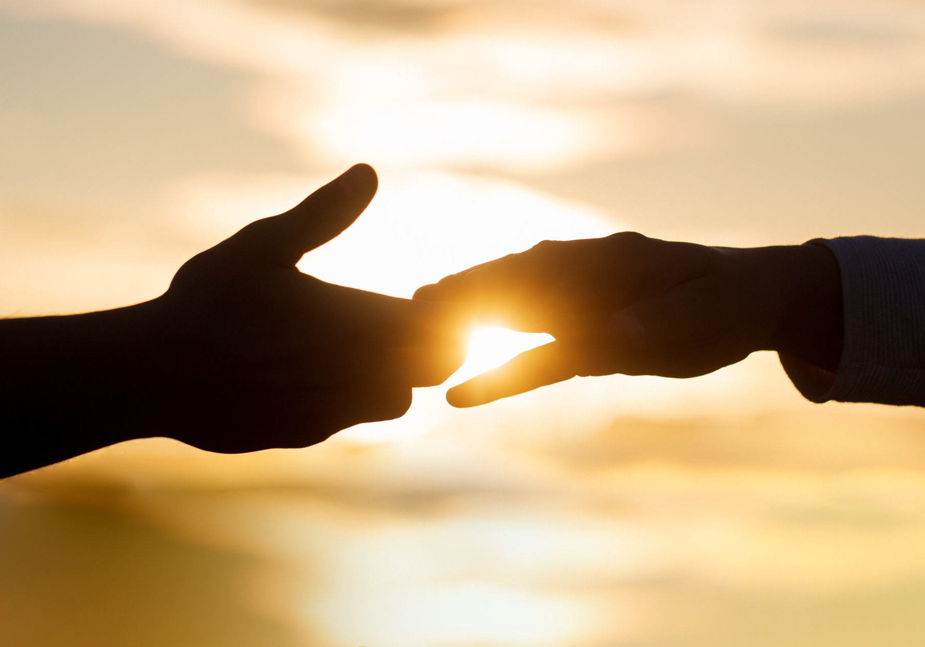 Giving a helping hand. Rescue, helping gesture or hands. Two hands silhouette on sky background, connection or help concept. The outstretched hands, salvation, help silhouette, concept of help